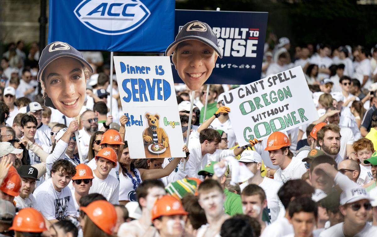 Fans hold up signs during ESPN’s College GameDay as it films at Penn State on Saturday, Sept. 27, 2025.  