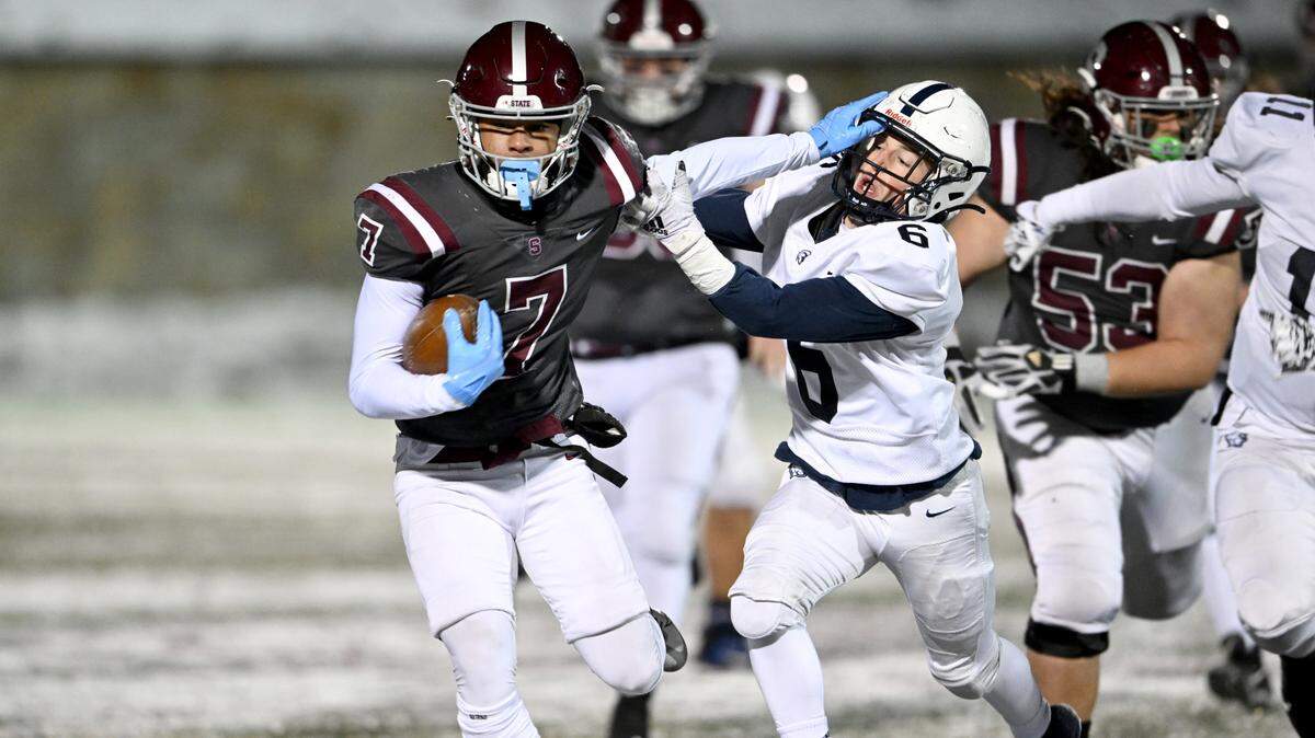State College’s D’Antae Sheffey pushes past McDowell’s Dominic Berarducci to score a touchdown during the game on Friday, Nov. 18, 2022.