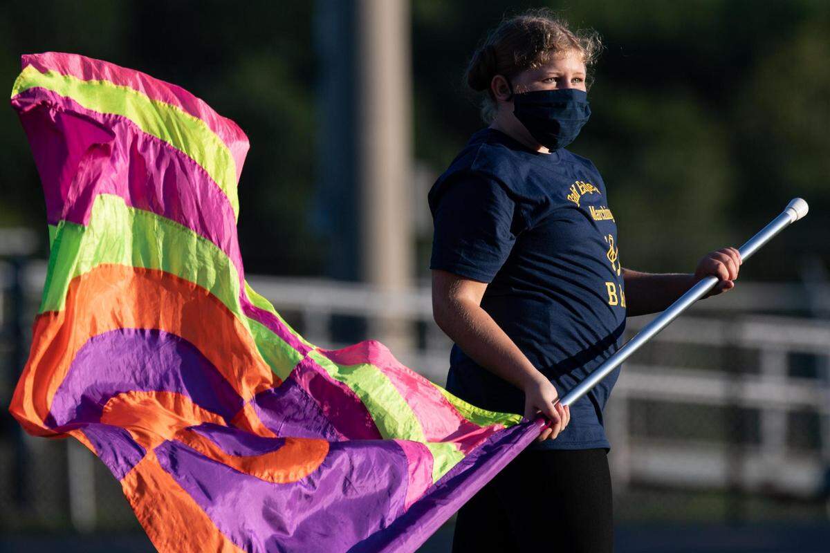 Bald Eagle Area High School marching band member waives a flag before Bald Eagle Area High School’s game against Martinsburg Central High School on Friday, Sept. 11, 2020 in Wingate, PA.