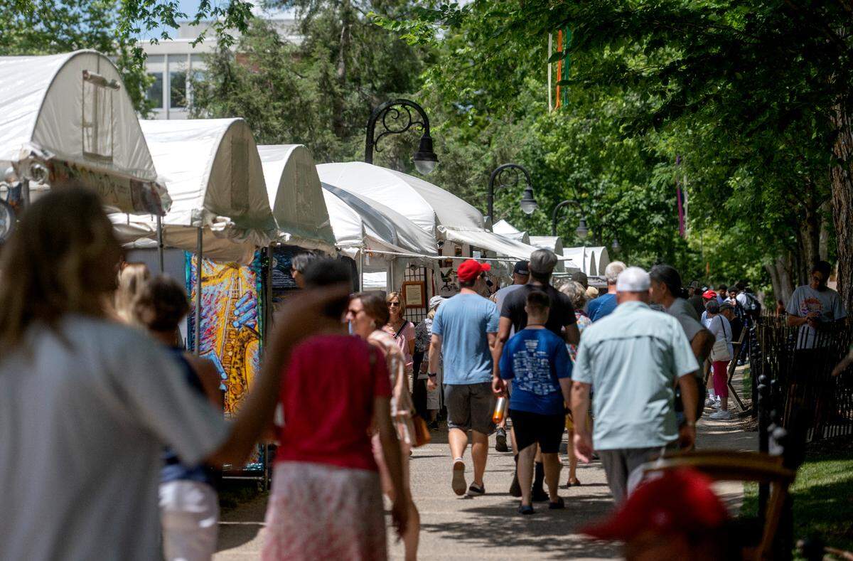 Visitors browse the artists along the Allen Street mall on the Penn State campus during the Central Pennsylvania Festival of the Arts on Thursday, July 14, 2022.