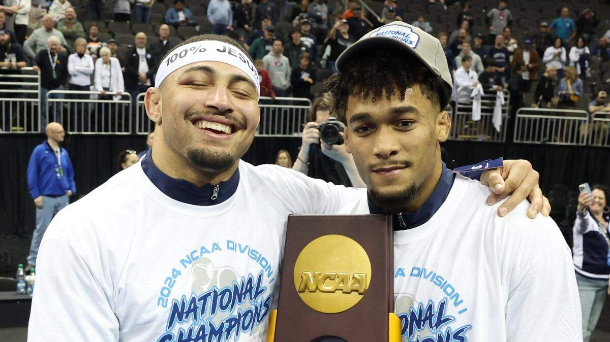 Mar 23, 2024; Kansas City, MO, USA; 174 pound Penn State Nittany Lions wrestler Carter Starocci and 197 pound Penn State Nittany Lions wrestler Aaron Brooks pose with the Championship trophy after winning their fourth National Title at the T-Mobile Center. Mandatory Credit: Reese Strickland-USA TODAY Sports