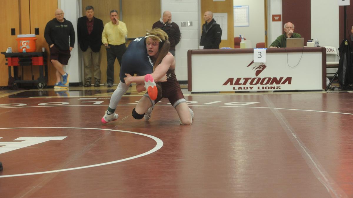 State College’s Jacob Campbell aims to finish off a takedown on McDowell’s Javarie Blue in their 133-pound quarterfinals match of the PIAA Class 3A Northwest Regional Championships on Friday, Feb. 24, 2023 in Altoona. Campbell beat Blue, 9-4.
