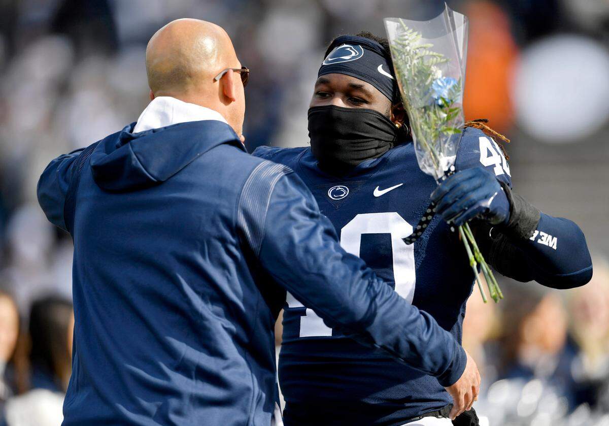 Penn State football coach James Franklin hugs linebacker Jesse Luketa during the senior day celebration before the game against Rutgers on Saturday, Nov. 20, 2021.