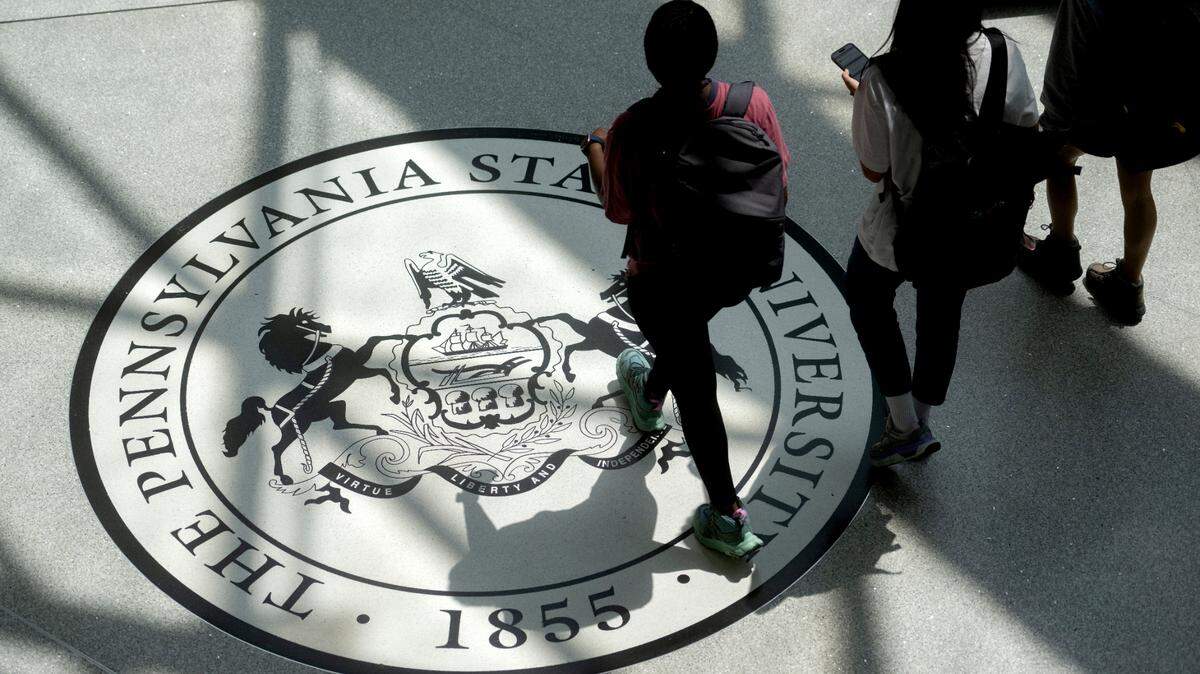 Students walk through the HUB-Robeson Center over the Pennsylvania State University logo on Thursday, July 20, 2023.