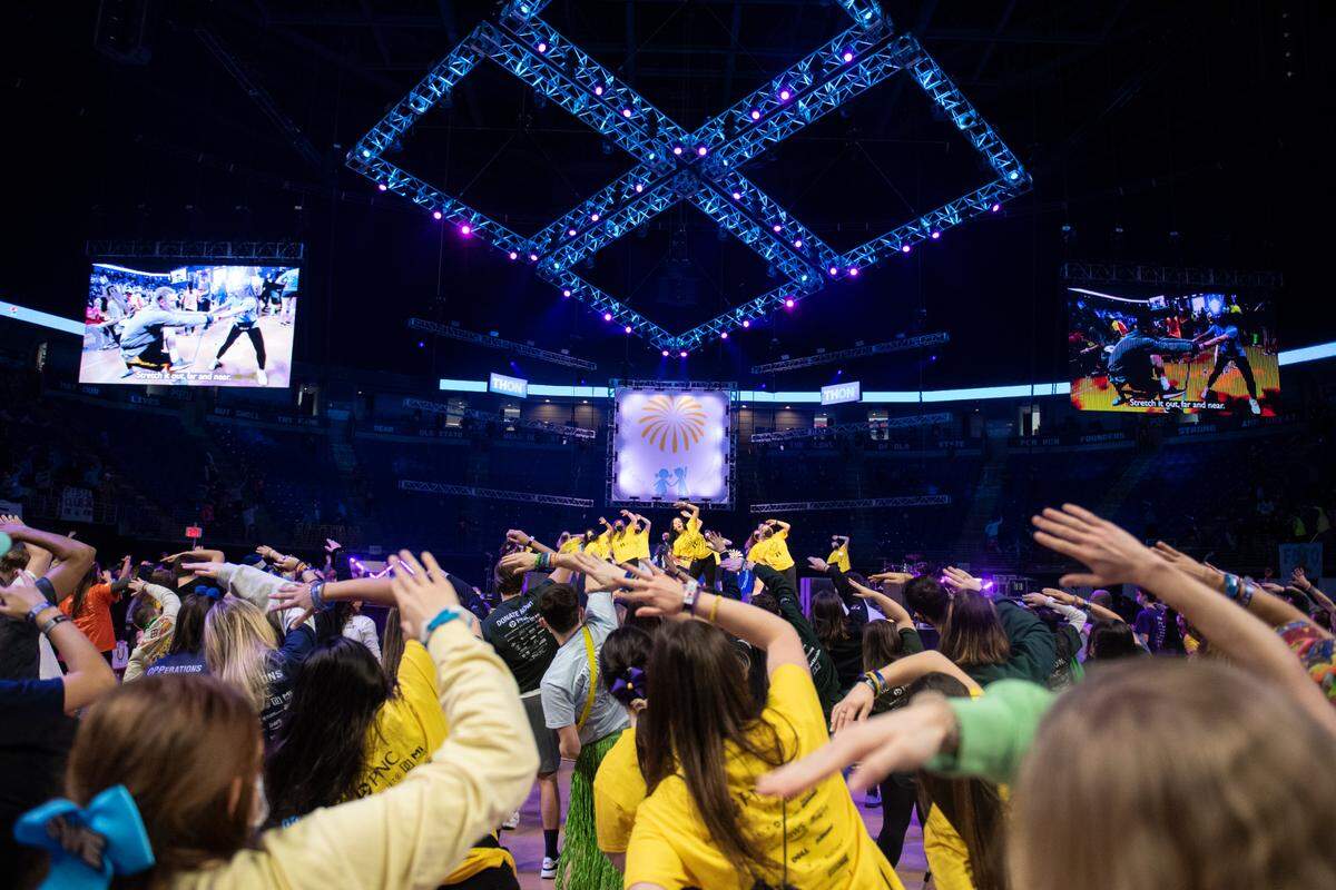 Dancer Relation Captions perform the Line Dance on stage during the Penn State IFC/Panhellenic Dance Marathon on Saturday at the Bryce Jordan Center.