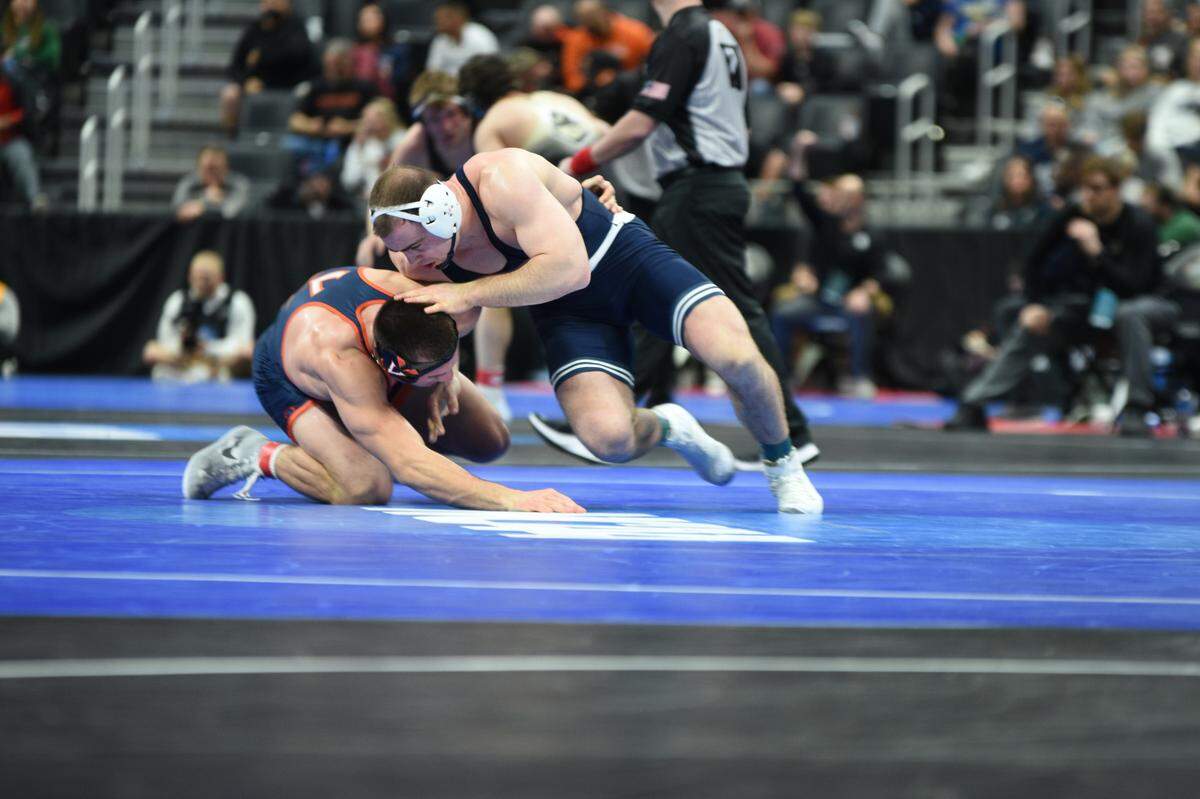 Penn State’s Max Dean escapes from Virginia’s Jay Aiello in their 197-pound second round match of the NCAA Championships on Thursday, March 17, 2022 at Little Caesars Arena in Detroit. Dean edged Aiello, 4-1.
