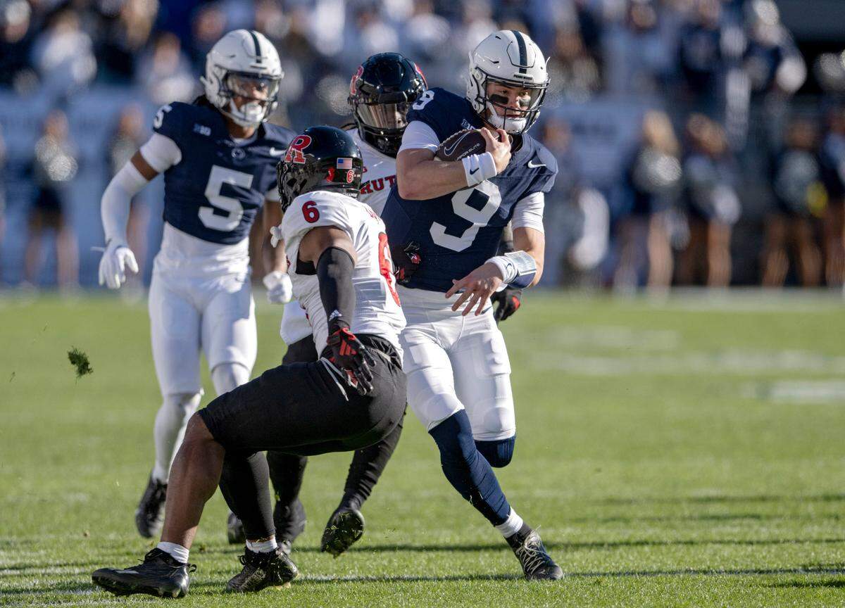 Penn State quarterback Beau Pribula cuts down the field with the ball from Rutgers defenders during the game on Saturday, Nov. 18, 2023.