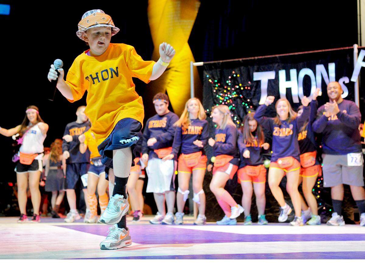 Four Diamonds child Tucker Haas dances as he performs the LMFAO song “Party Rock Anthem” in the Thon variety show during the Penn State IFC/Panhellenic Dance Marathon in 2012.