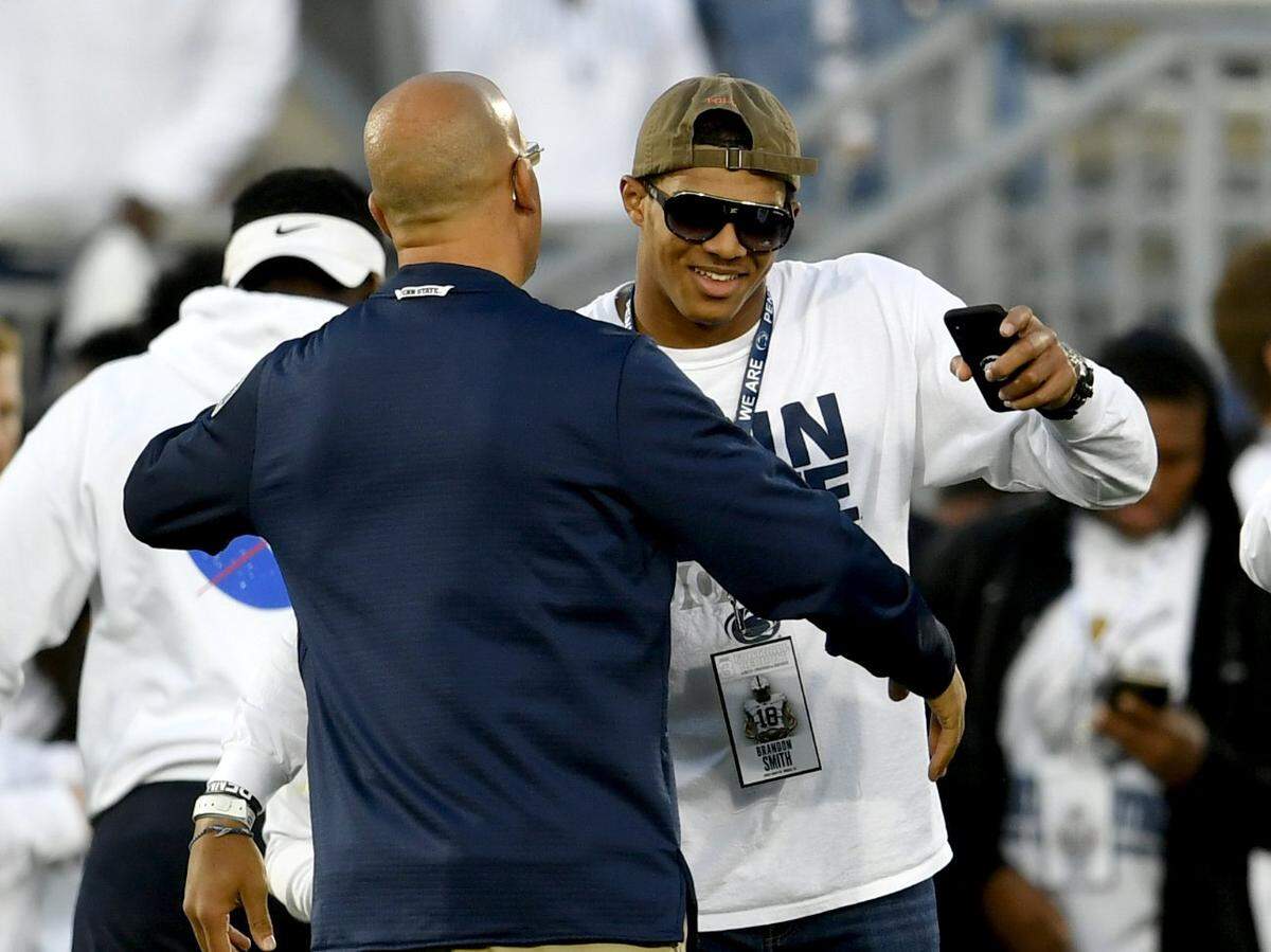 Penn State commit Brandon Smith, a five-star linebacker, greets Penn State football coach James Franklin on the field before the Nittany Lions’ game against Ohio State on Sept. 29.