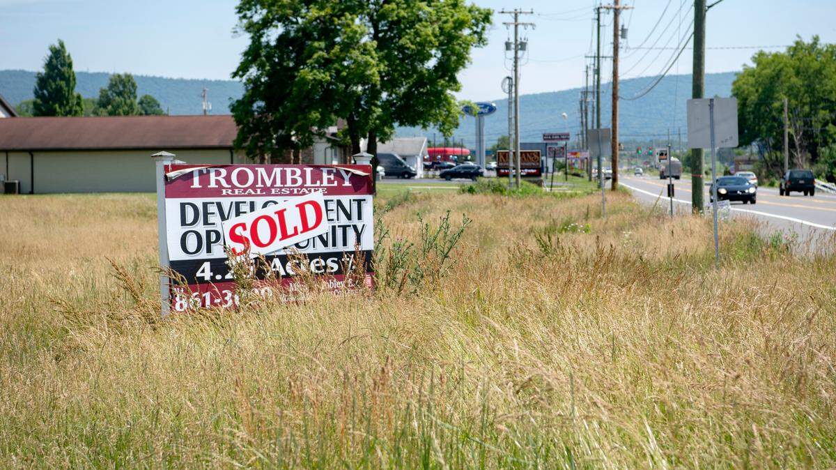 The 4.25-acre lot on the corner of Benner Pike and Amberleigh Lane has a sold sign and developers are planning for a four-story hotel.
