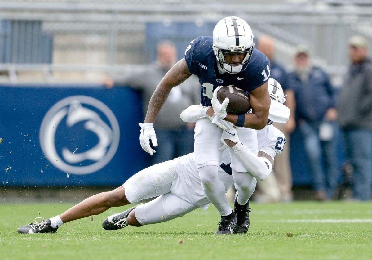 Penn State wide receiver Kyron Hudson makes a catch and is tripped up by Penn State cornerback Lamont Payne Jr. during the Blue-White game on Saturday, April 26, 2025.