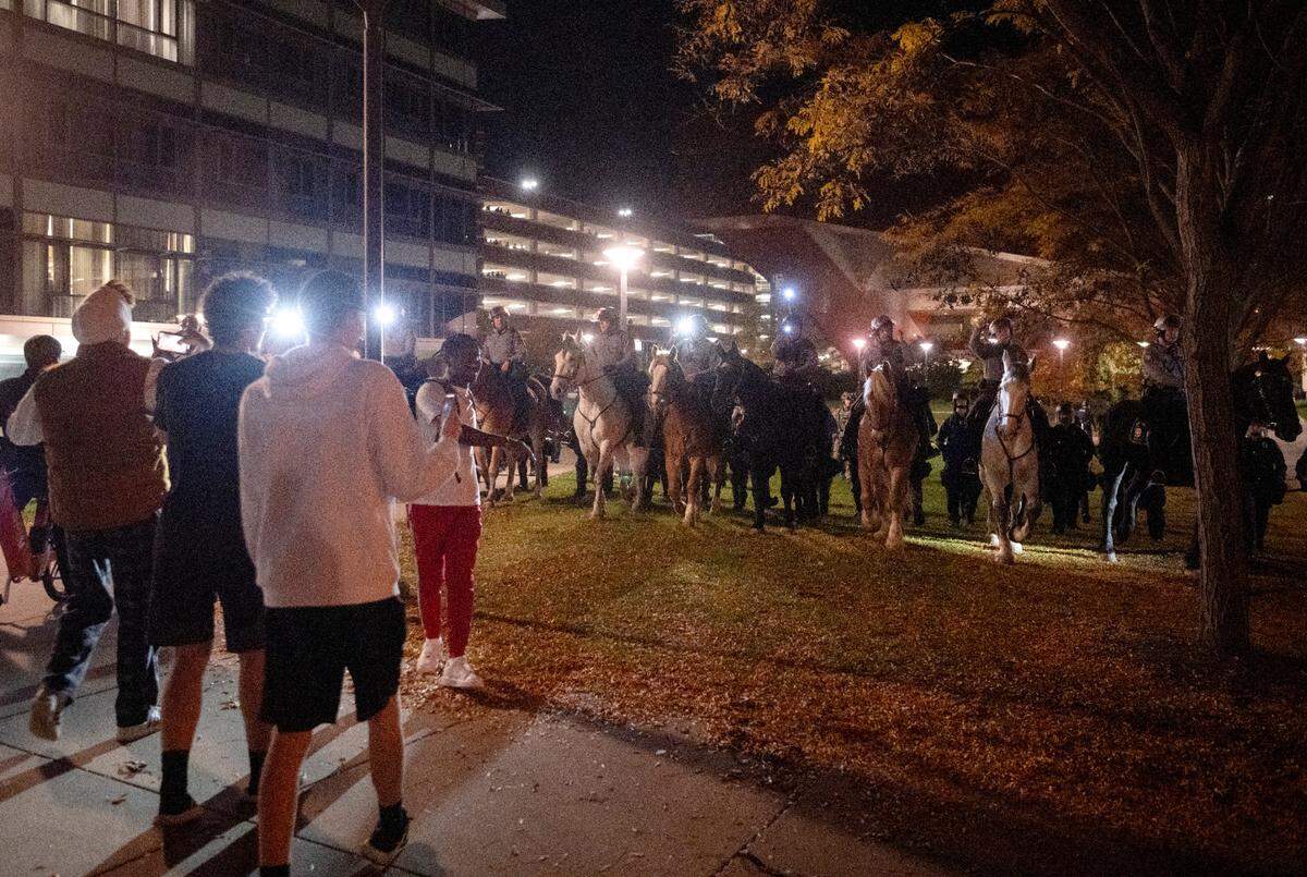 Police on horses and in riot gear work to disperse the crowd around the Thomas Building after the event was canceled on Monday, Oct. 24, 2022.