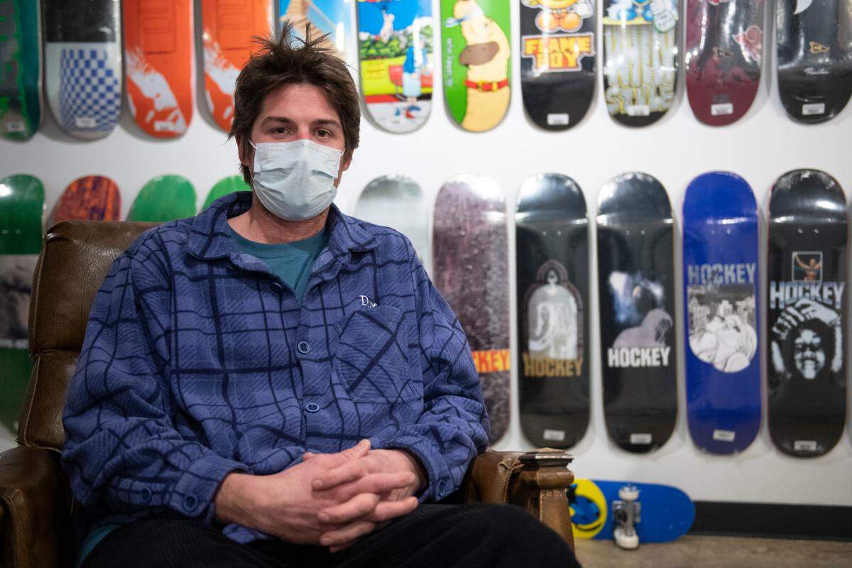 Jake Johnson, professional skateboarder and co-owner of IQ Skateshop, poses for a portrait inside of his store on Thursday, Jan. 27, 2022 in State College, Pa.