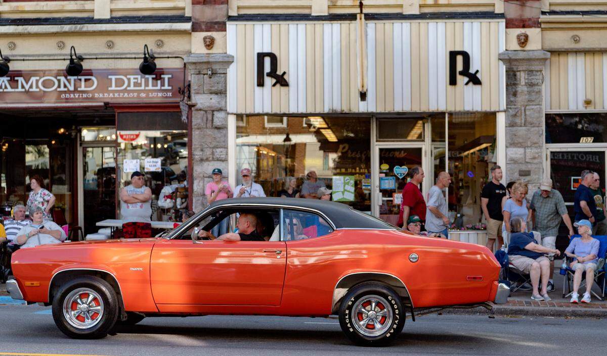 A Plymouth Duster cruises past the crowd on Allegheny Street for the Bellefonte Cruise on Friday, June 17, 2022.