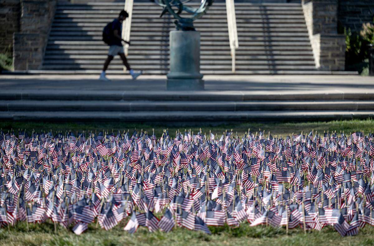 A patch of American flags on the Old Main lawn on Tuesday, Sept. 9, 2025.  The 2,997 flags honor each victim killed on Sept. 11, 2001.  