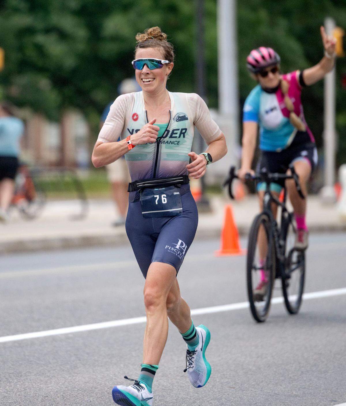 Caroline Moyer runs down Curtin Road towards the finish line of the Ironman 70.3 Pennsylvania Happy Valley on Sunday, June 30, 2024.  Moyer was the first female finisher with a time of 5:02:11.  