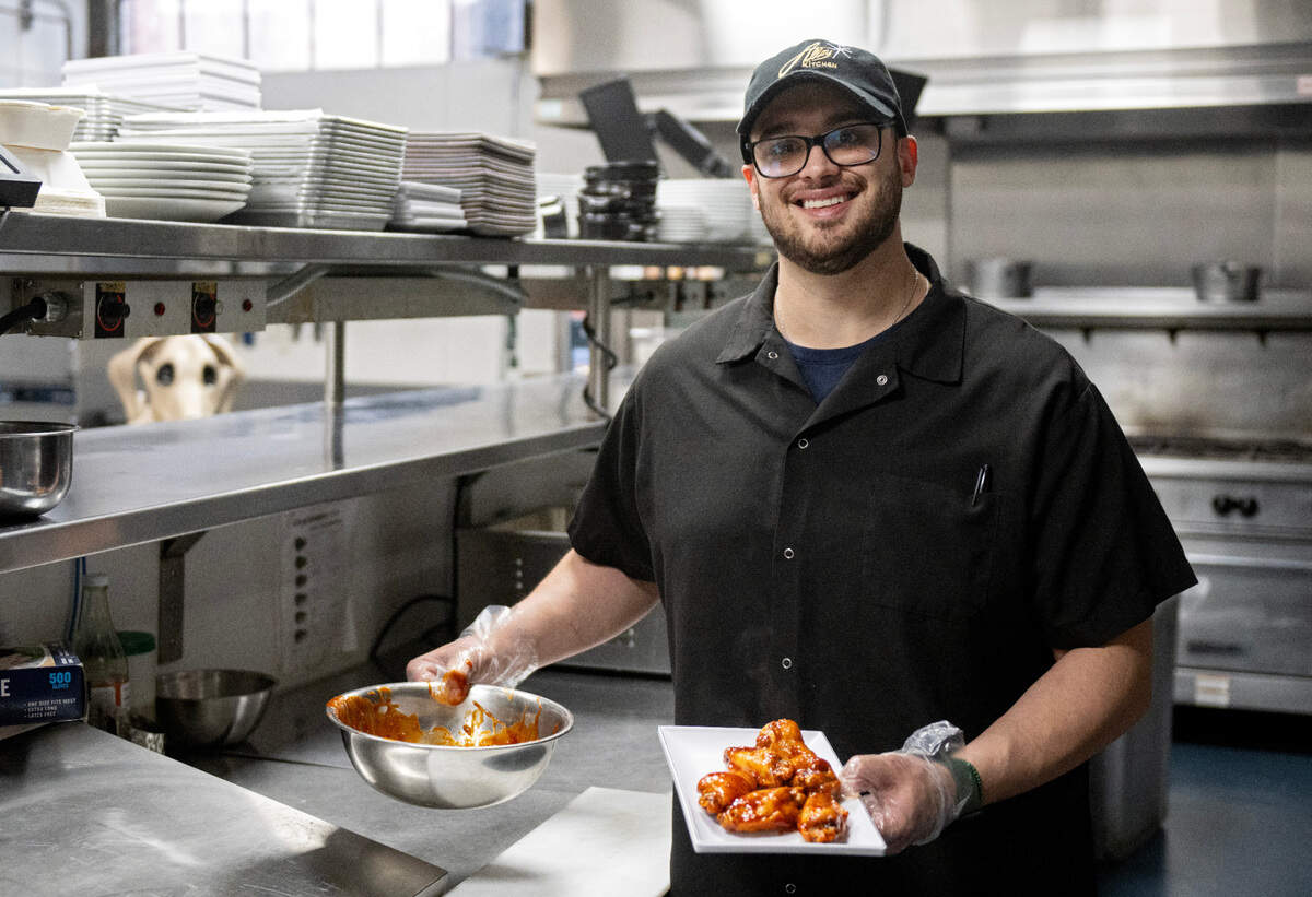 Tony Caracillo, the owner of Alloy Kitchen, holds an order of Nelly’s Jumbo Sweet and Spicy wings on Thursday, April 10, 2025.