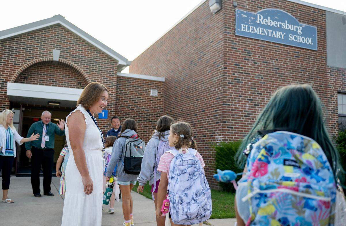 Principal Katie Bish welcomes students to the first day of school at Miles Township Elementary on Tuesday, Aug. 27, 2024.  