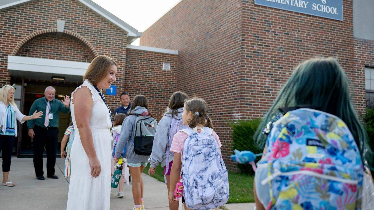 Principal Katie Bish welcomes students to the first day of school at Miles Township Elementary on Tuesday, Aug. 27, 2024.