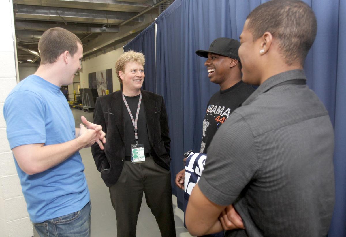 Bernie Punt talks with Andrew Silsby, left, Stanley Okoye and Justin Jacobs before performing artist Drake’s concert at the Bryce Jordan Center in April 2010.