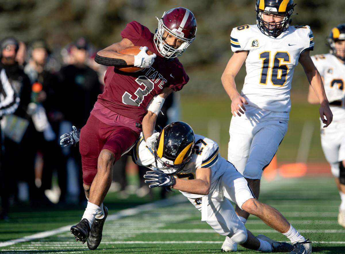 Mt. Lebanon’s Marco Alandete tries to trip up State College’s Jashaun Green during the PIAA class 6A semifinal game on Saturday, Dec. 4, 2021 at Mansion Park. Mt. Lebanon won, 49-28.