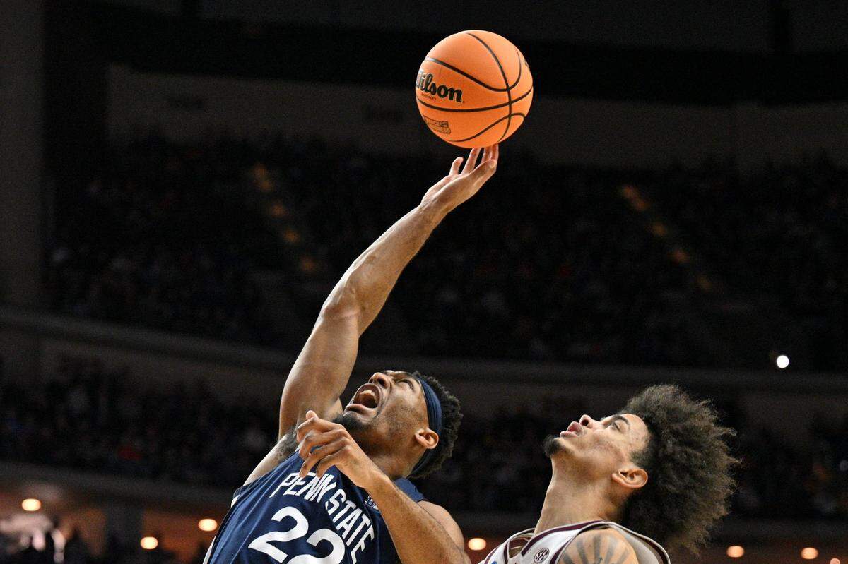 Penn State Nittany Lions guard Jalen Pickett (22) reaches for the ball against Texas A&M Aggies forward Andersson Garcia (11) during the first half of Thursday’s game at Wells Fargo Arena.