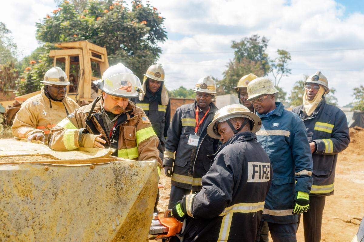 MIke Kull, left, works with a crew of firefighters through Africa Fire Mission.