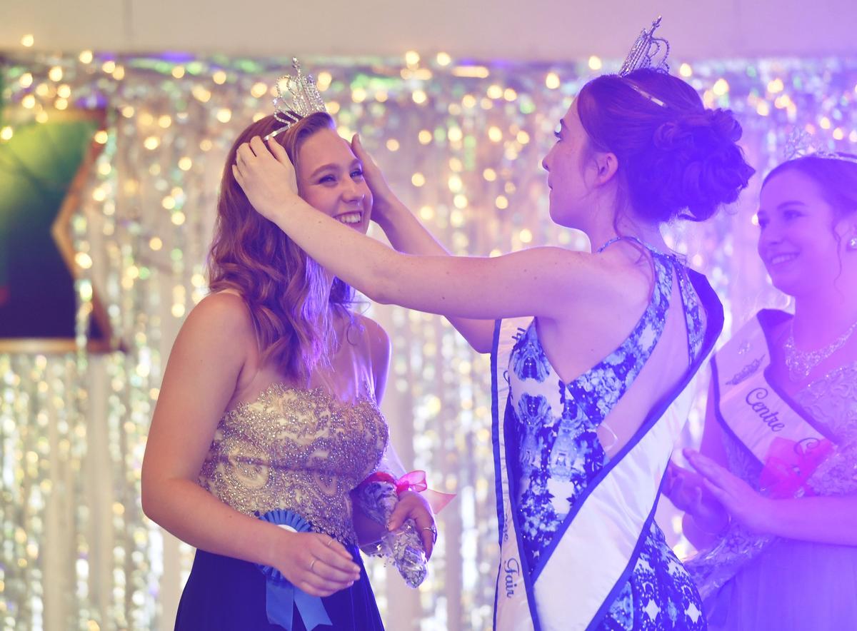 Morgan Bair is crowned the 2019 Grange Fair Queen by 2018-2019 queen Amelia Miller on Wednesday.