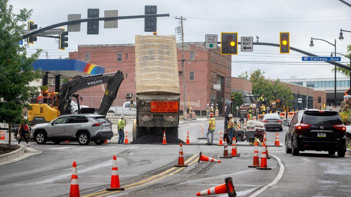 Construction crews work on paving the intersection of College Avenue and Atherton Street on Thursday, Sept. 26, 2024.