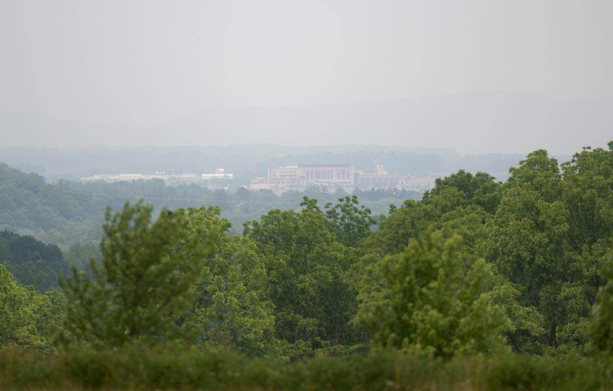 Mount Nittany Medical Center is seen through smoky skies from Oak Hall Regional Park on Wednesday, June 7, 2023.