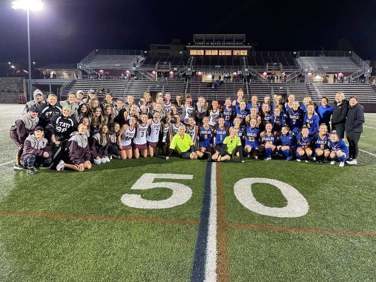 Both State College and Line Mountain field hockey players came together after the Little Lions’ 1-0 win on Thursday, Oct. 21 to celebrate lead official Rebecca Trunzo’s retirement. Trunzo (front row, left), began her field hockey career 55 years ago at Memorial Field as a player.