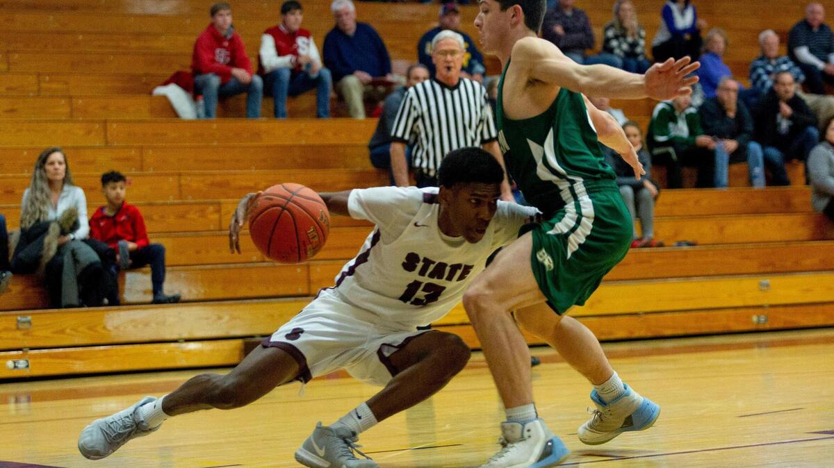 State College guard Cam Villarouel slips while driving baseline during the consolation game of the Skip Coleman Tip Off Tournament against Bishop Shanahan at State College Area High School on Saturday, Dec. 8, 2018.