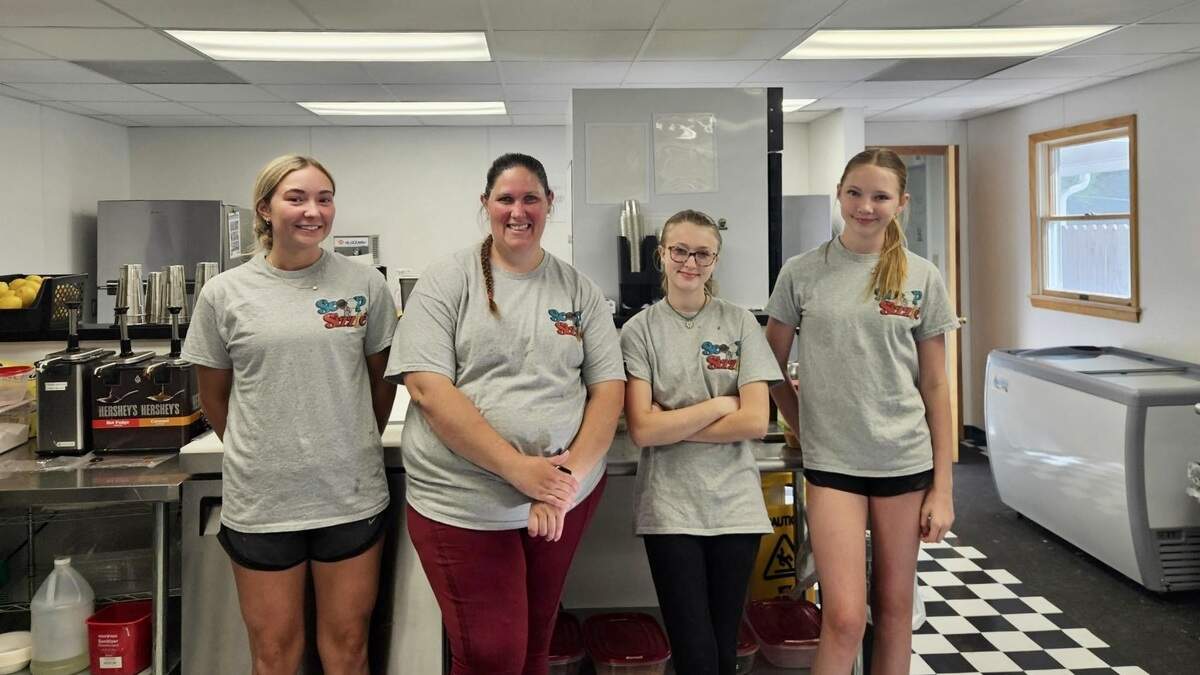Co-owner Melanie Wilkins, second from left, poses with workers at the new Scoop & Sizzle shop at 4576 Penns Valley Road in Spring Mills.