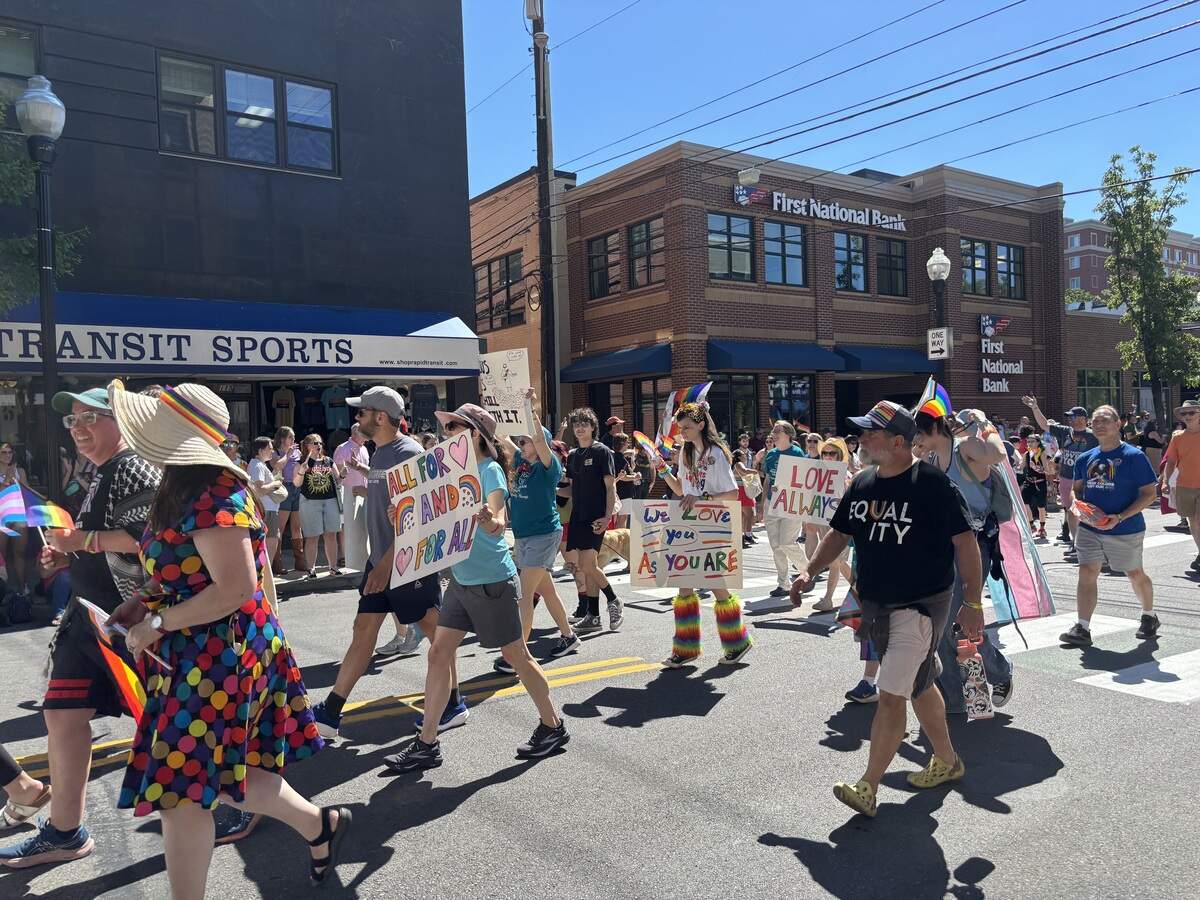 Marchers move along South Allen Street during the State College Pride parade on Saturday, June 13, 2026.