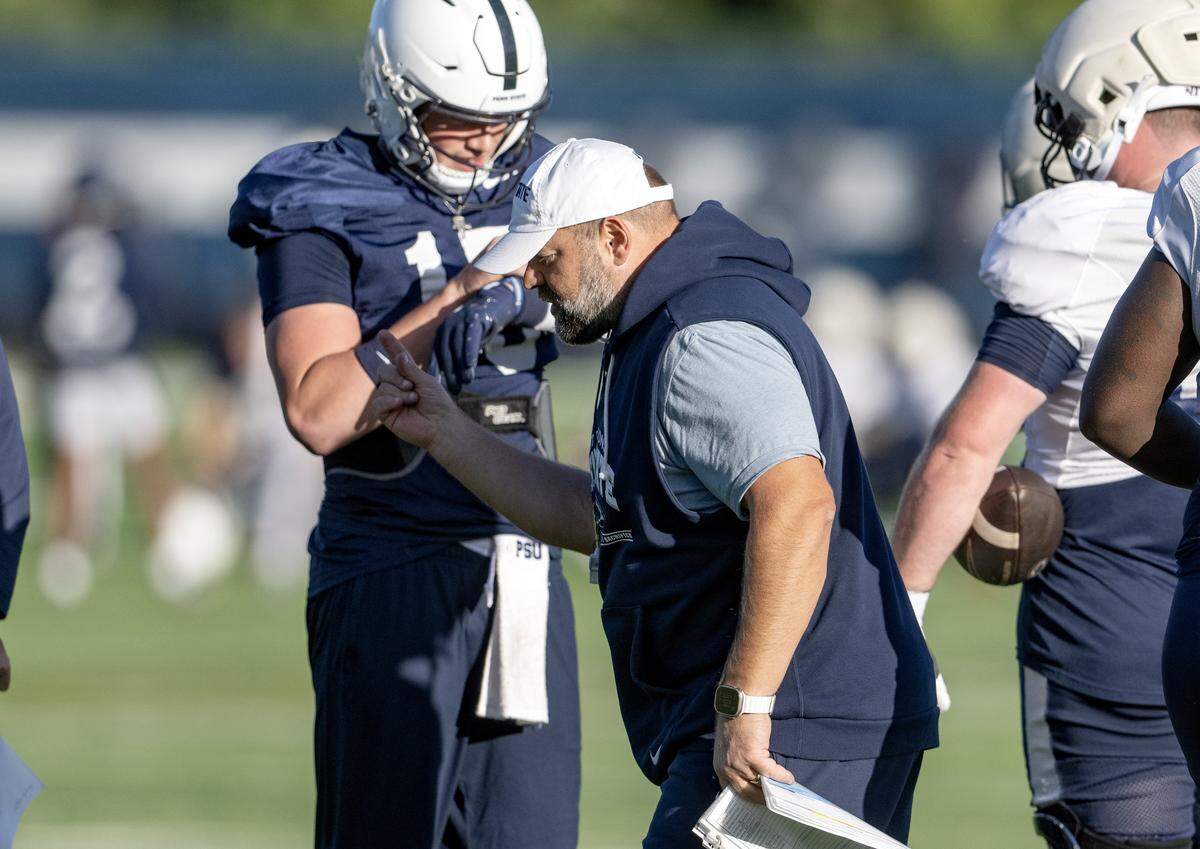Penn State offensive coordinator Andy Kotelnicki gives the play to quarterback Drew Allar during practice on Wednesday, Oct. 8, 2025.  