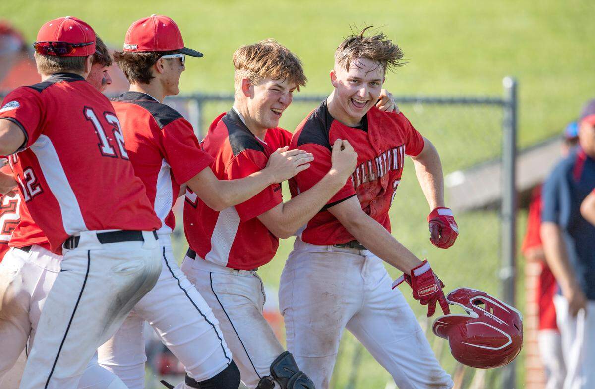 Bellefonte players swarm Trevor Johnson after his out of the park homer to win the District 6 4A championship game against Juanita 14-2 in the fifth inning on Tuesday, May 31, 2022.