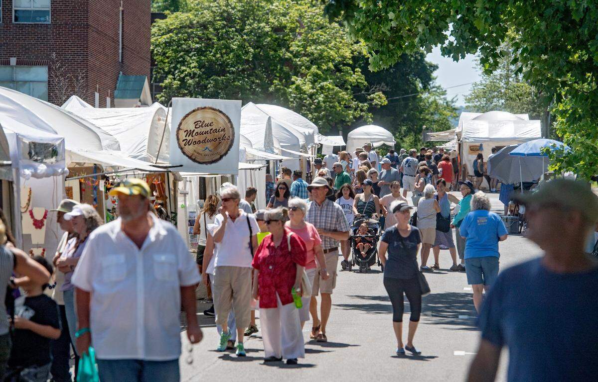 Patrons browse the artists booths on South Fraser Street during the Central Pennsylvania Festival of the Arts in 2018.