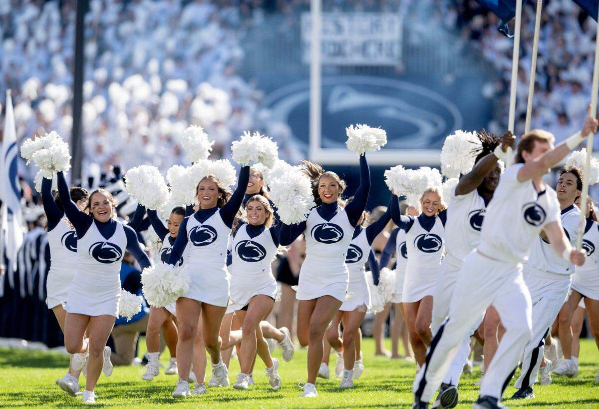 Penn State cheerleaders run out ahead of the football team for the game against Ohio State on Saturday, Nov. 2, 2024.