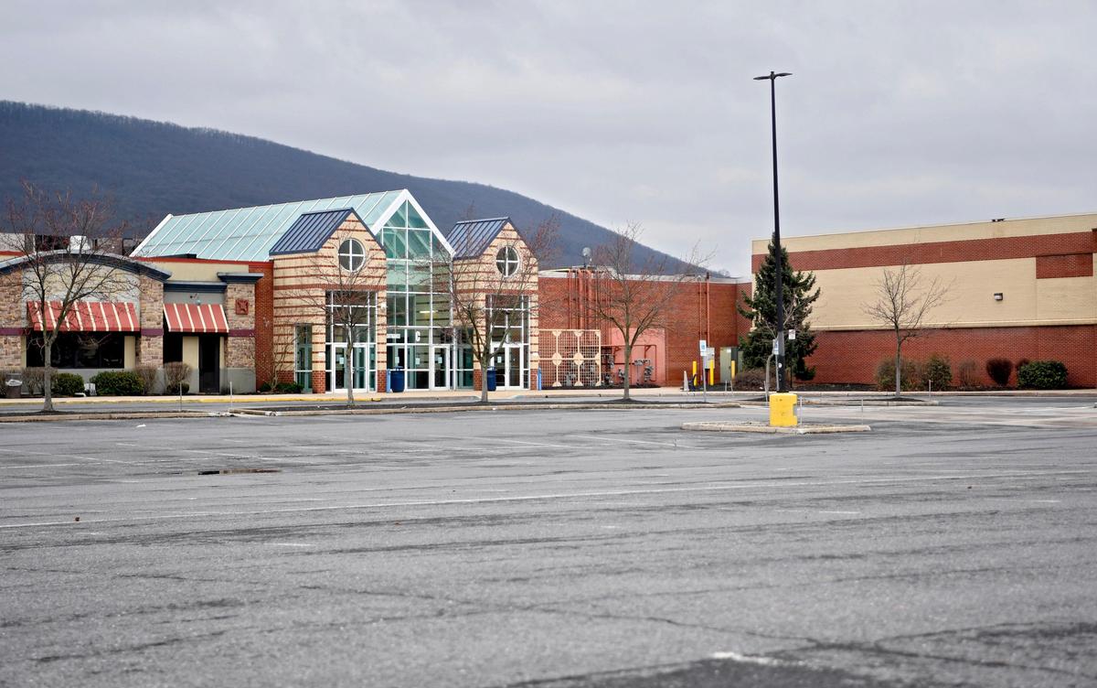 An empty parking lot at the closed Nittany Mall on Tuesday. The mall is among “nonessential” businesses to close due to a statewide shutdown as a precaution against the spread of COVID-19.