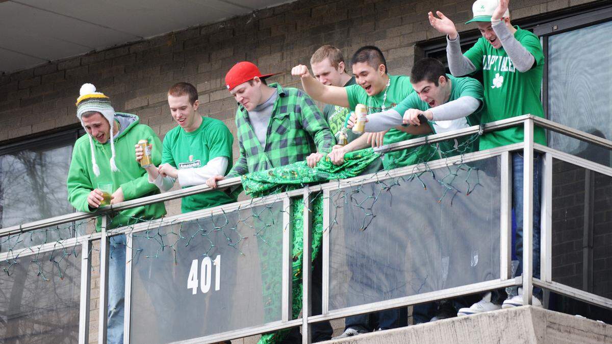 State Pattys Day party goers shout to people walking along Beaver avenue from the Penn Towers complex Saturday, Feb. 27, 2010. CDT/Michelle Bixby