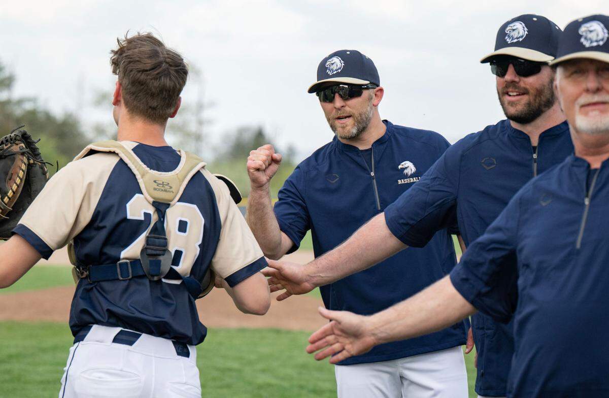 Bald Eagle Area baseball coach Ryan MacNamara fist bumps catcher Hayden Stimer as he is introduced for the game against Bishop Carroll on Tuesday, April 29, 2025.