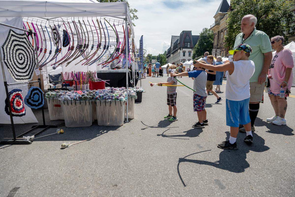 Kids try out Ziggy’s Bows at the 39th Annual Bellefonte Arts and Crafts Fair on Friday, Aug. 5, 2022.