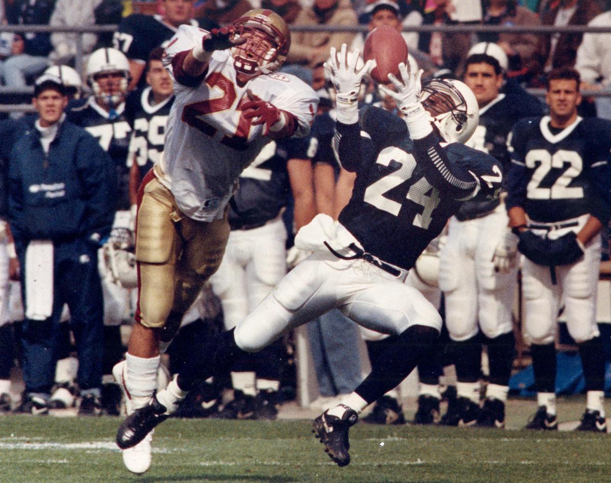 Penn State wide receiver O.J. McDuffie makes a catch ahead of a Boson College defender during the 1992 game.