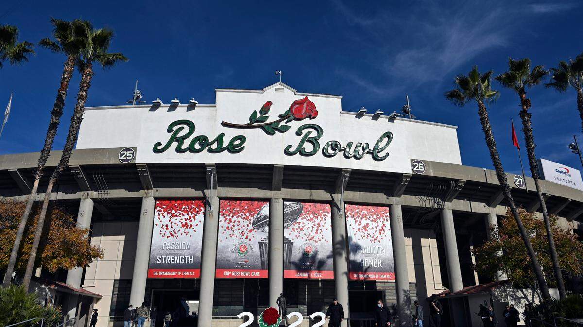 The exterior of the stadium is seen before the Rose Bowl NCAA college football game between Utah and Ohio State Saturday, Jan. 1, 2022, in Pasadena, Calif. Flipping the current college football playoff from four-teams to a 12-teams for the final two years of the current television contract will give those in charge of the postseason a look at how it works before committing to anything long term. But, The Granddaddy of Them All wants the CFP management committee to assure game organizers that their game will continue to be played annually on New Year’s Day. (AP Photo/John McCoy, File)