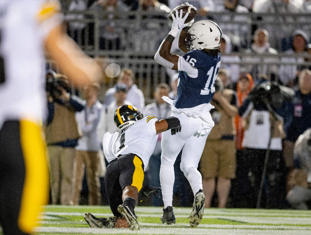 Penn State tight end Khalil Dinkins makes a catch for a touchdown around Iowa’s Xavier Nwankpa during the game on Saturday, Sept. 23, 2023.