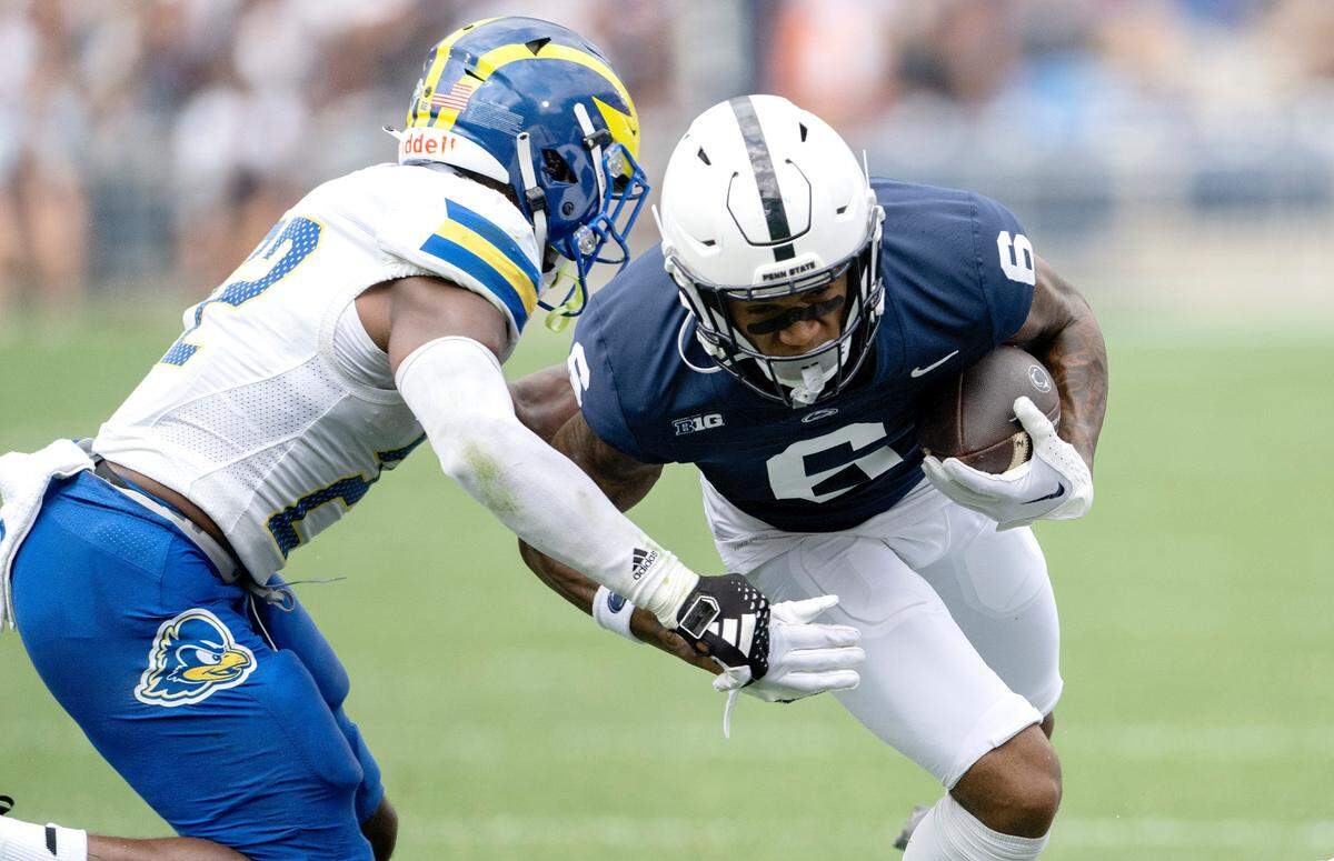 Penn State wide receiver Harrison Wallace III makes a catch and tries to cut past a Delaware defender during the game on Saturday, Sept. 9, 2023.