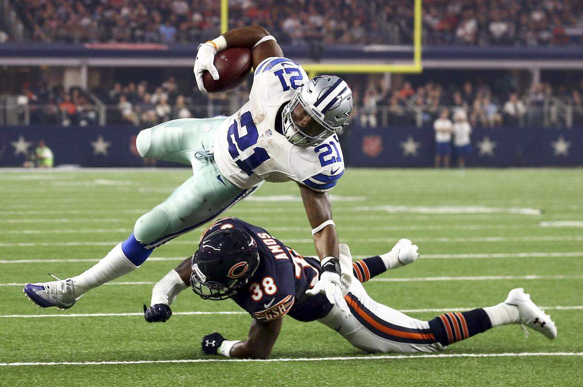 Dallas Cowboys running back Ezekiel Elliott (21) gets hit by Chicago Bears free safety Adrian Amos (38) in the second quarter of an NFL game at AT&T Stadium Sunday, Sept, 24, 2016.