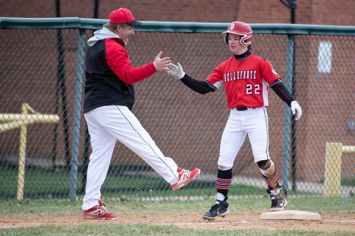 Triston Heckman high-fives the third base coach after hitting an RBI triple during a PIAA baseball game between Bellefonte and Jersey Shore on Friday in Bellefonte.