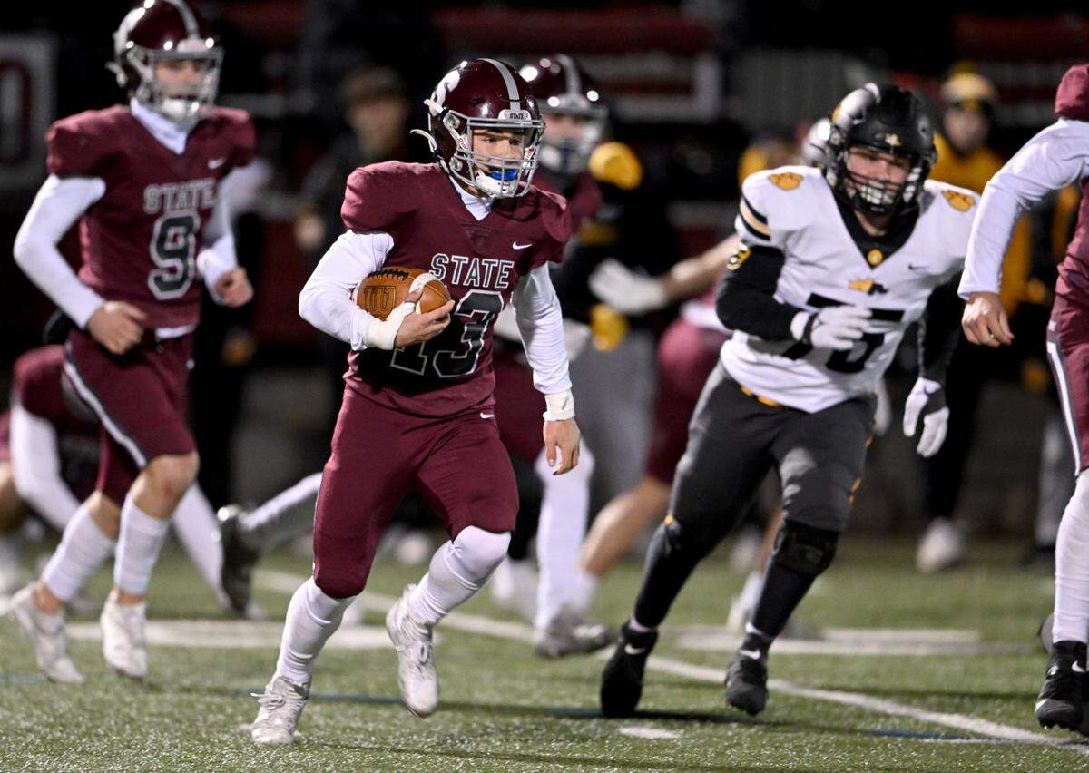 State College’s Cooper Brushwood (center) runs down the field with the ball after making his second interception in the game against North Allegheny in the PIAA class 6A quarterfinals on Friday, Nov. 25, 2022 at Memorial Field.