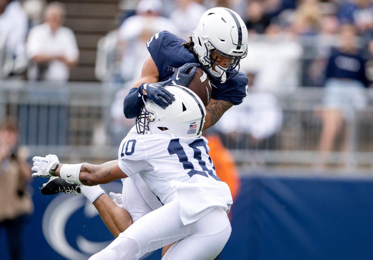 Wide receiver Omari Evans makes a catch and runs in for a touchdown around safety Mehki Flowers during the Penn State Blue-White game on Saturday, April 15, 2023 at Beaver Stadium.